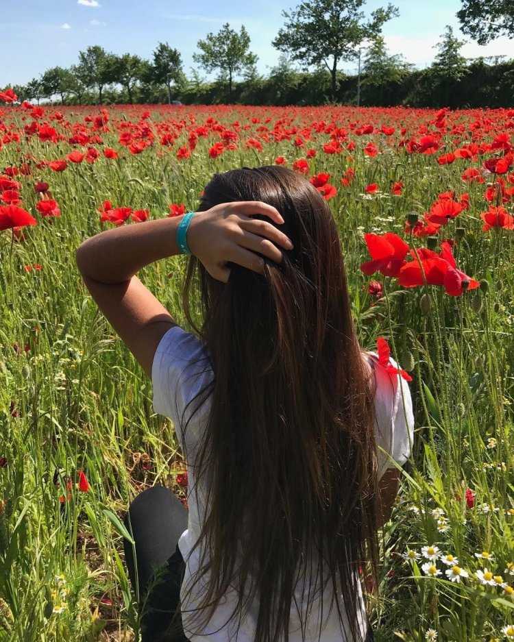 Девушка брюнетка со спины с цветами