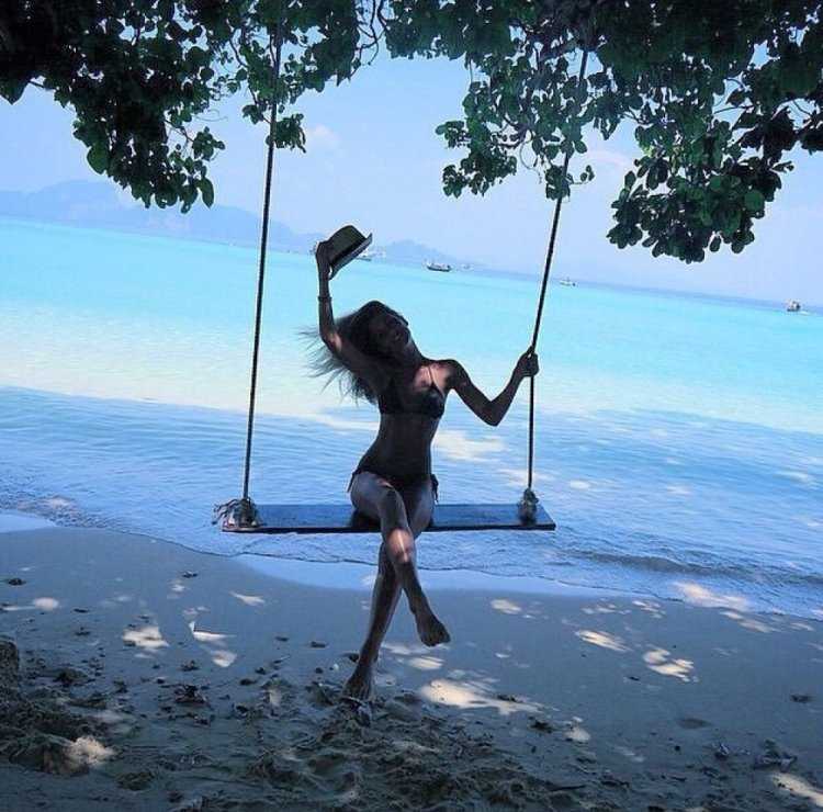 Девушка на качели у моря