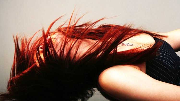 Девушка с красными волосами со спины