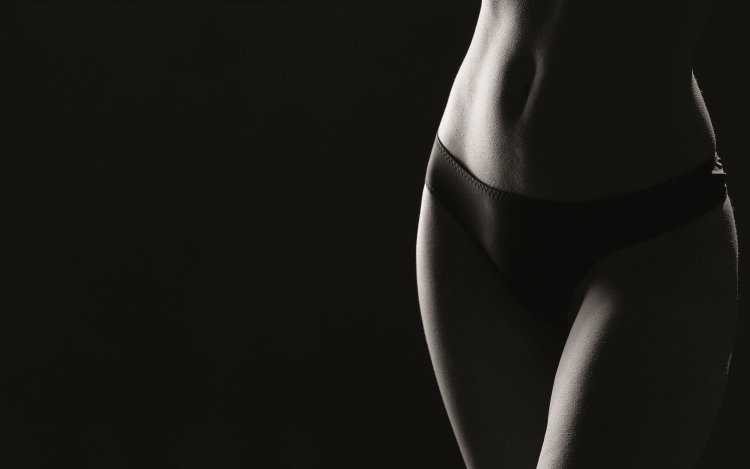 Женское тело на темном фоне