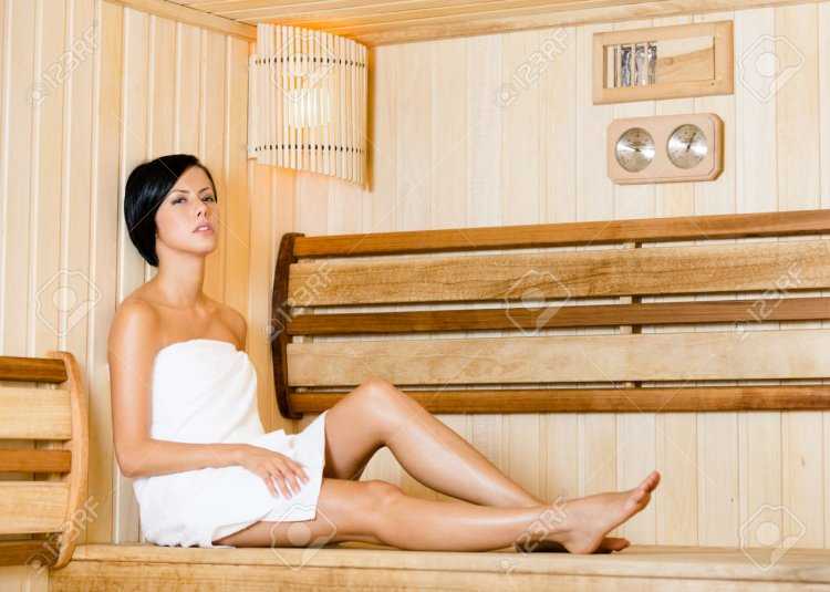 Девушка красиво сидит в сауне