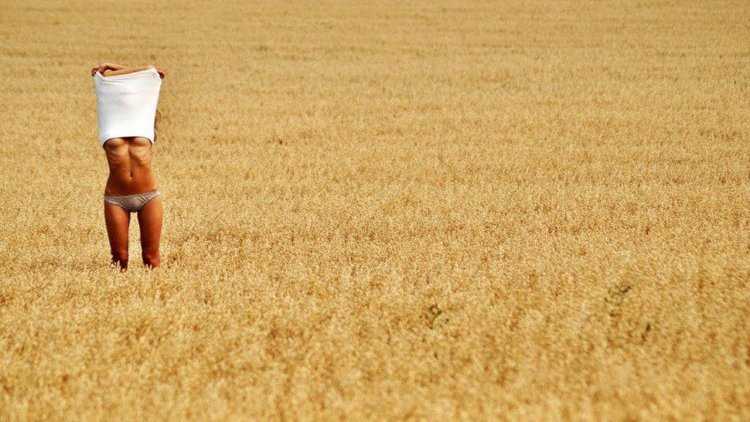 Девочка загорает в поле