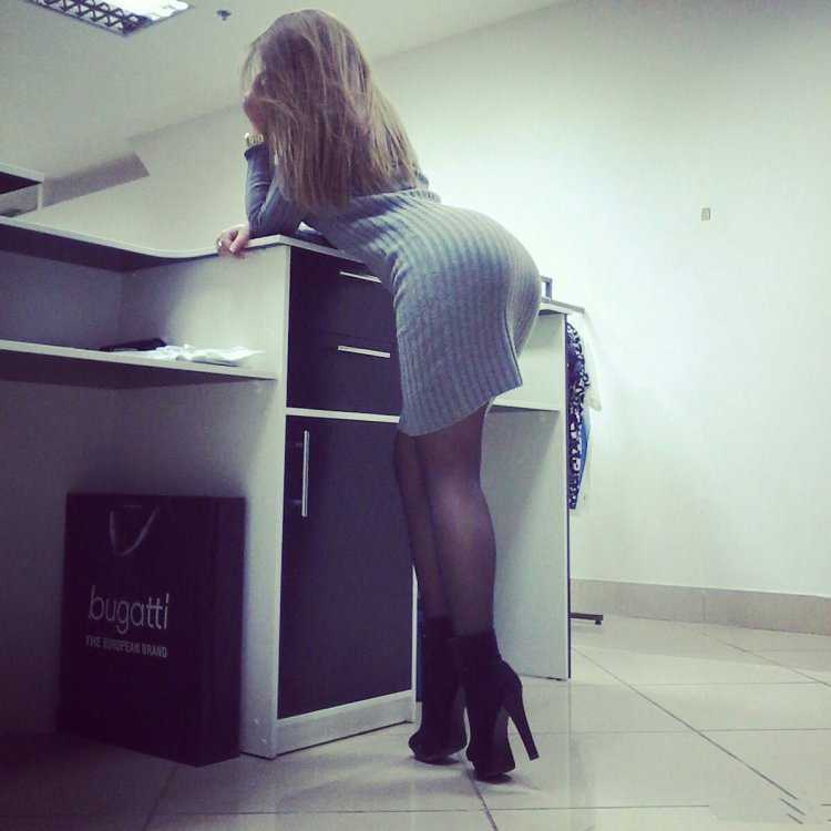 Девушка нагнулась в офисе